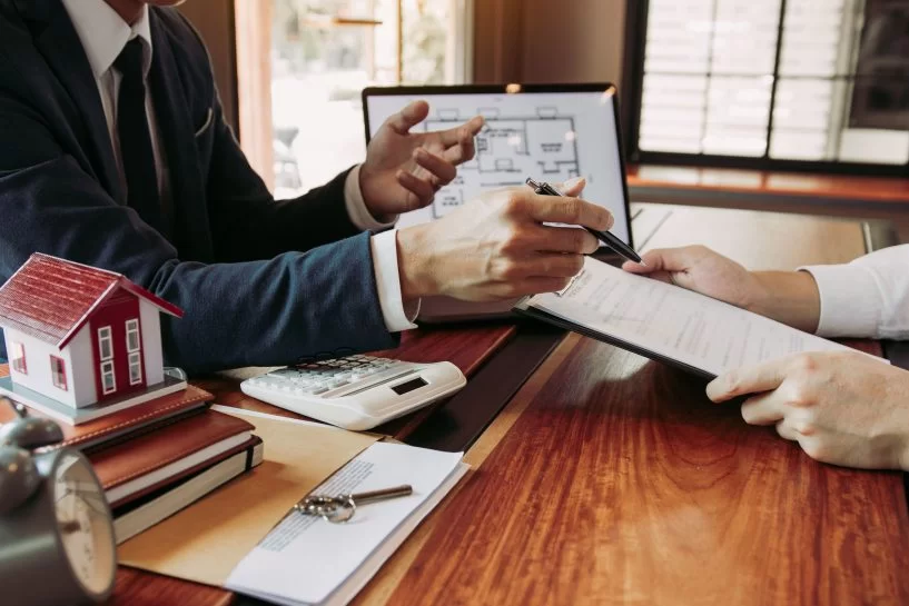 Homeowners reviewing insurance policy with professional agent